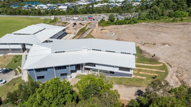 An Aerial View of a Large Building Surrounded by Trees and Grass — Architectural Glass Solutions QLD in Cooroy, QLD