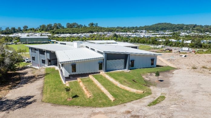 A Large White House Surrounded by Grass and Trees — Architectural Glass Solutions QLD in Cooroy, QLD