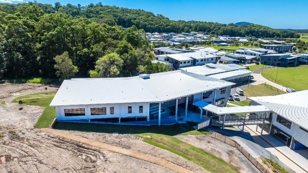 An Aerial View of a Large White Building Surrounded by Trees — Architectural Glass Solutions QLD in Cooroy, QLD