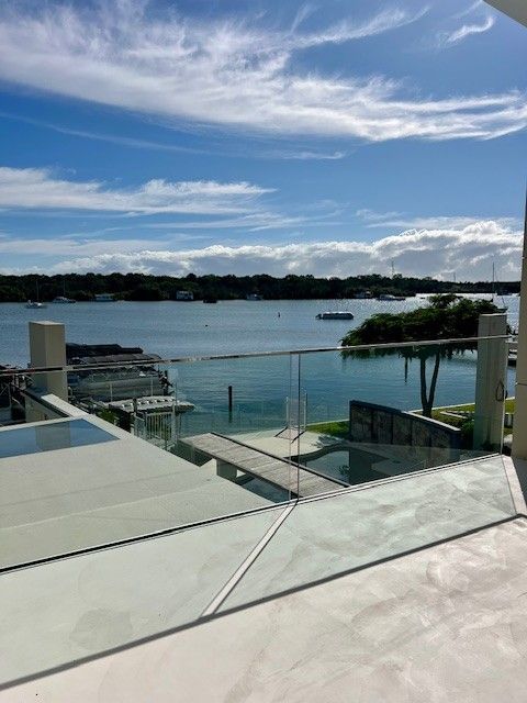 A view of a body of water from a balcony with a glass railing. — Architectural Glass Solutions QLD in Cooroy, QLD