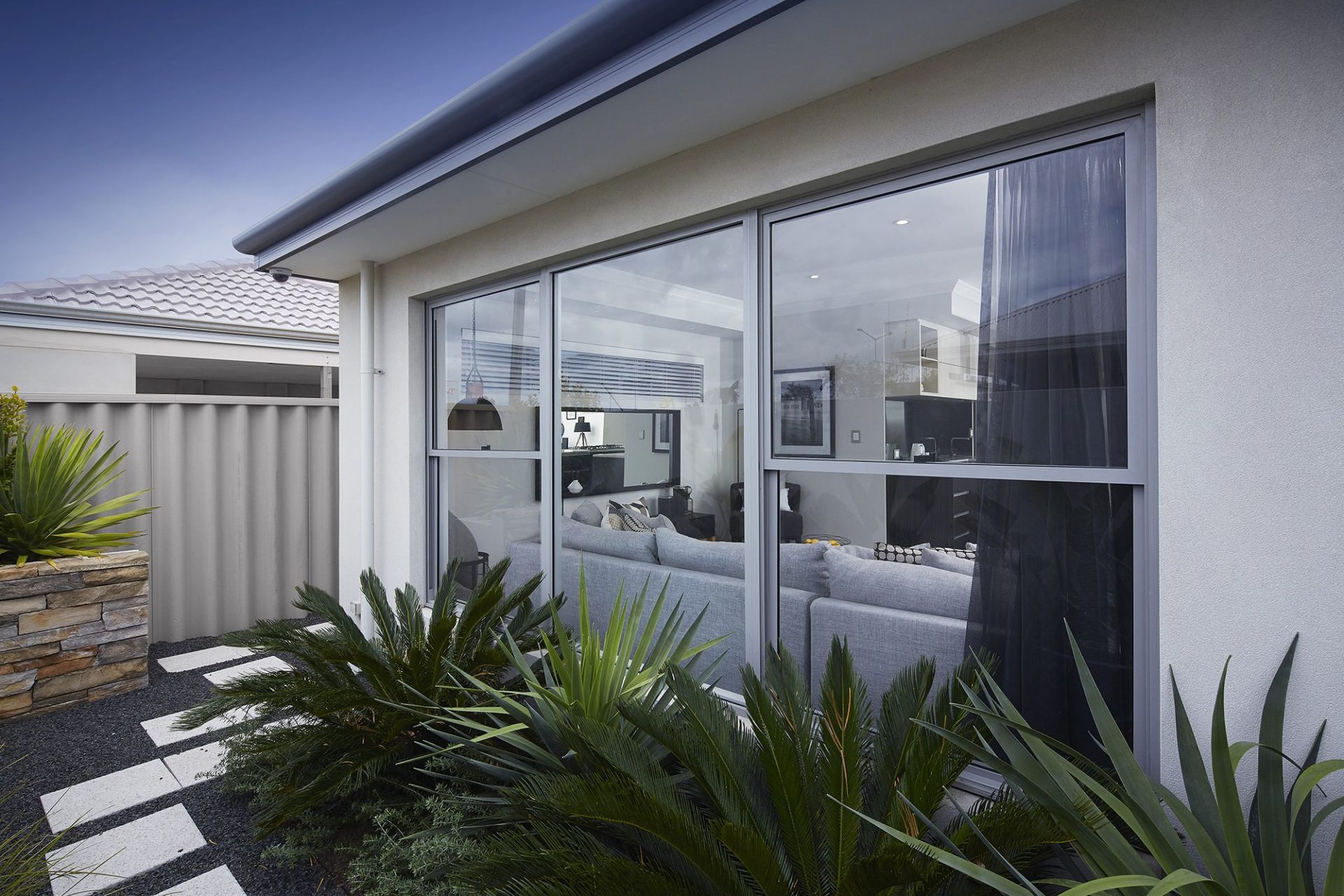 Exterior View of a House With a Large Window Reflecting the Living Room — Architectural Glass Solutions QLD in Cooroy, QLD