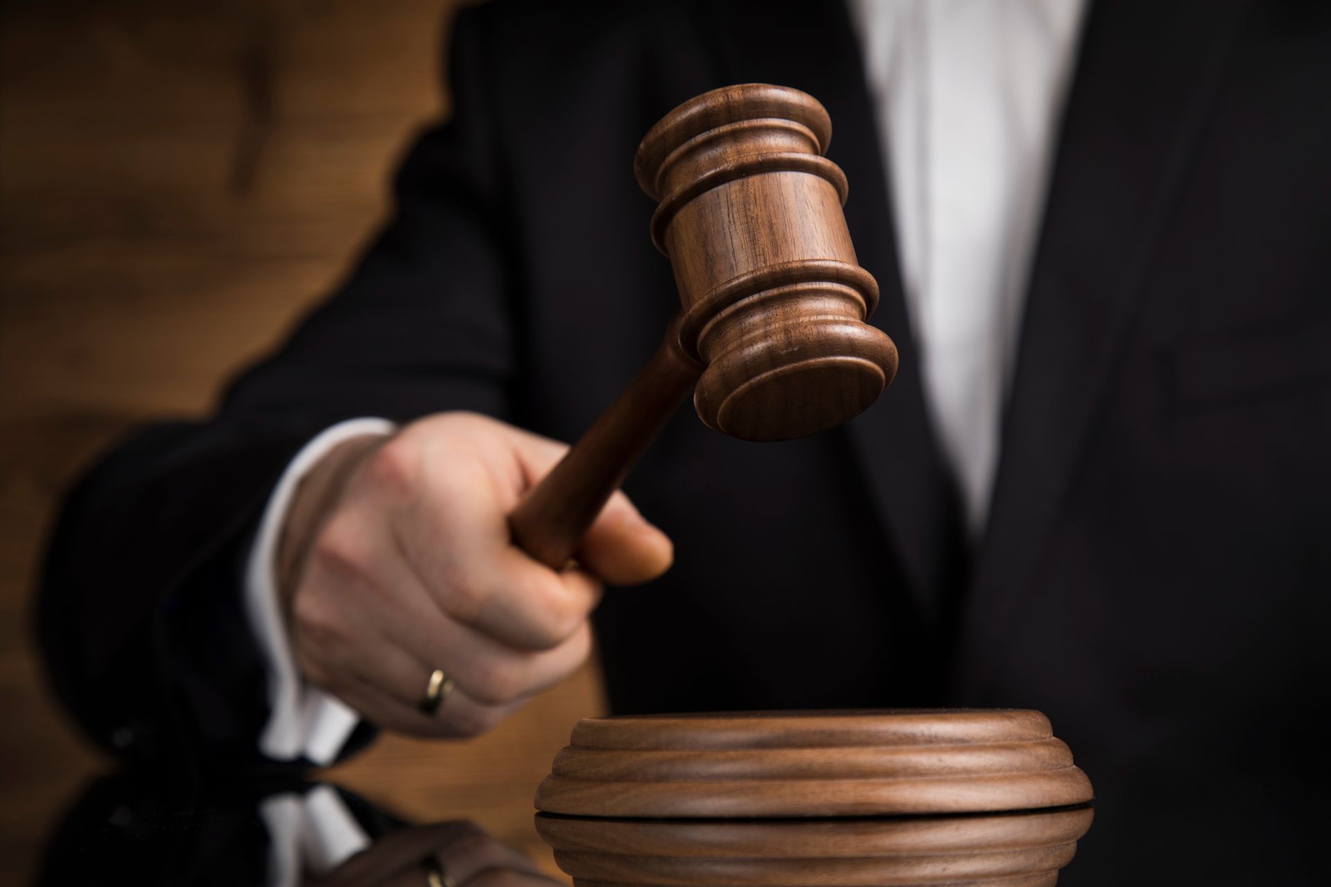 Person in suit holding a gavel, representing DWAI and DUI charges in Colorado.