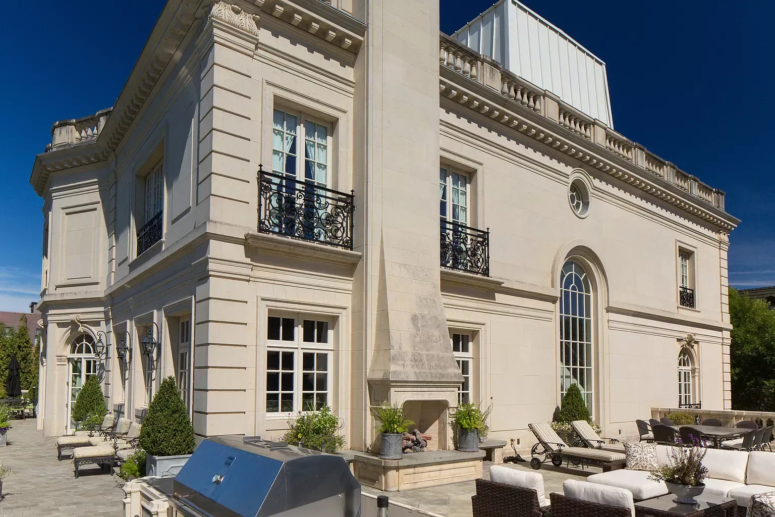 A large white building with a grill in front of it