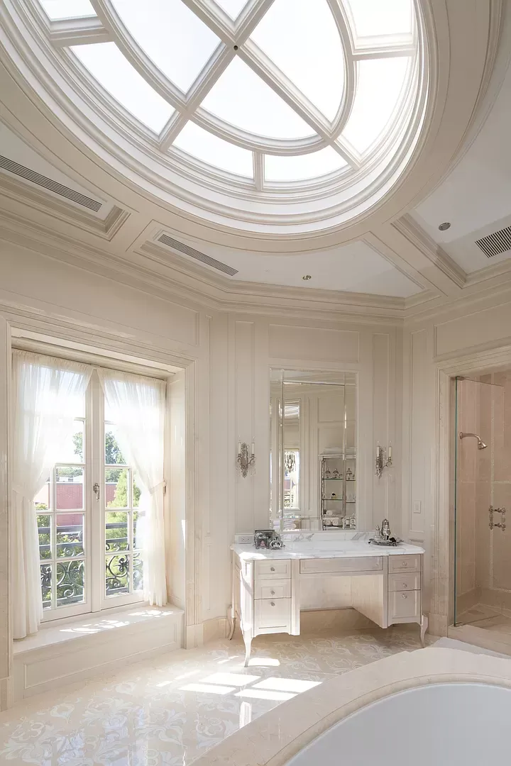 A bathroom with a skylight and a tub