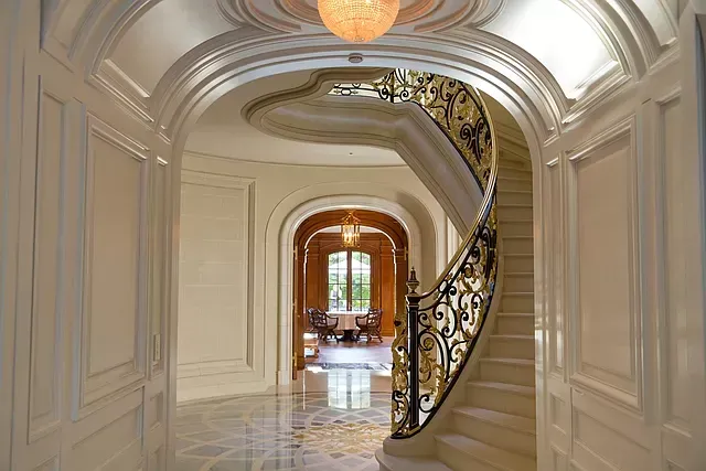 There is a spiral staircase in the middle of the hallway.