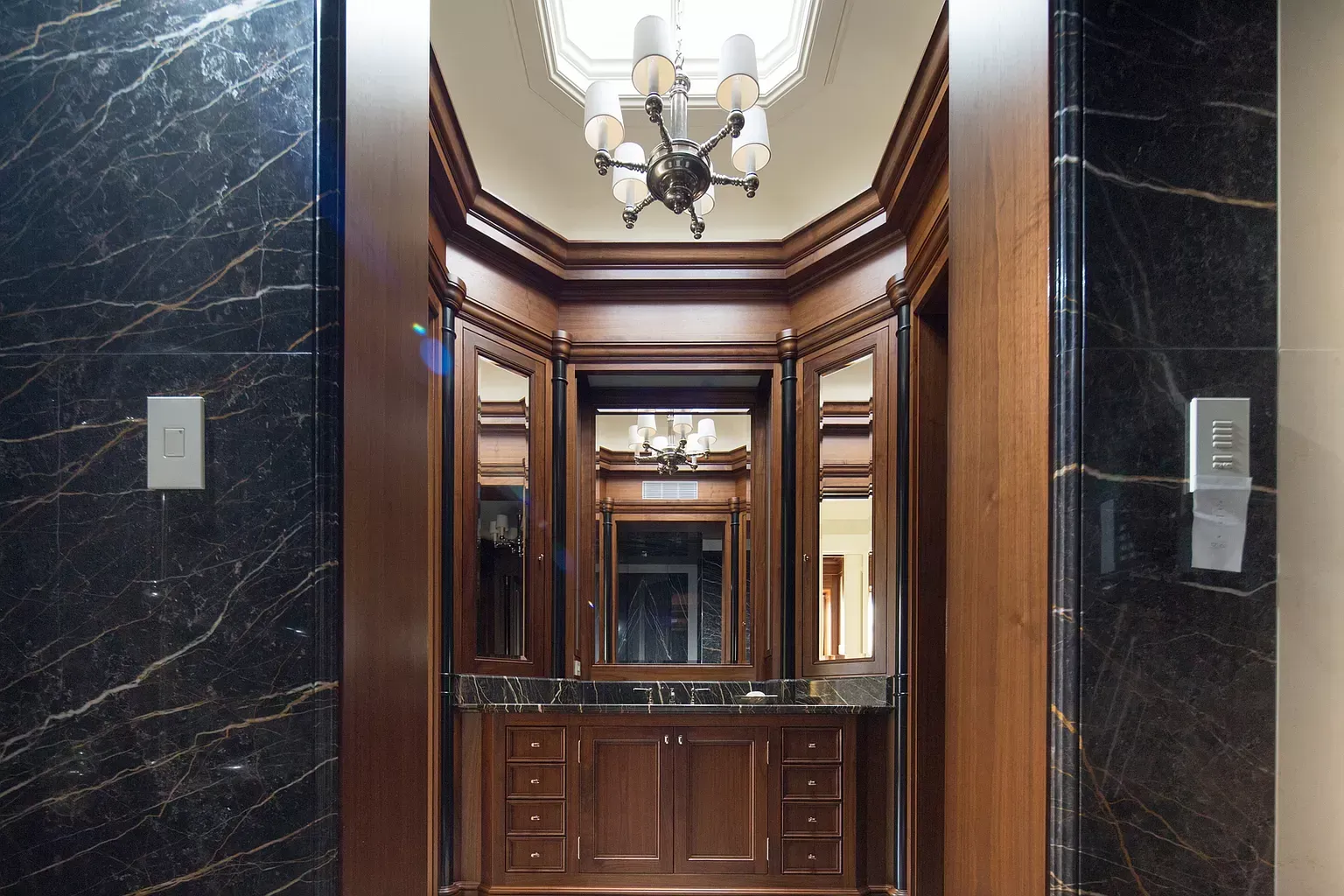 A bathroom with a chandelier hanging from the ceiling