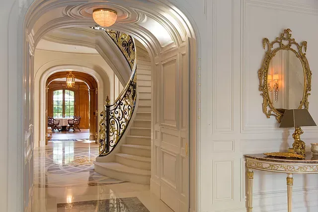 There is a spiral staircase in the middle of the hallway.