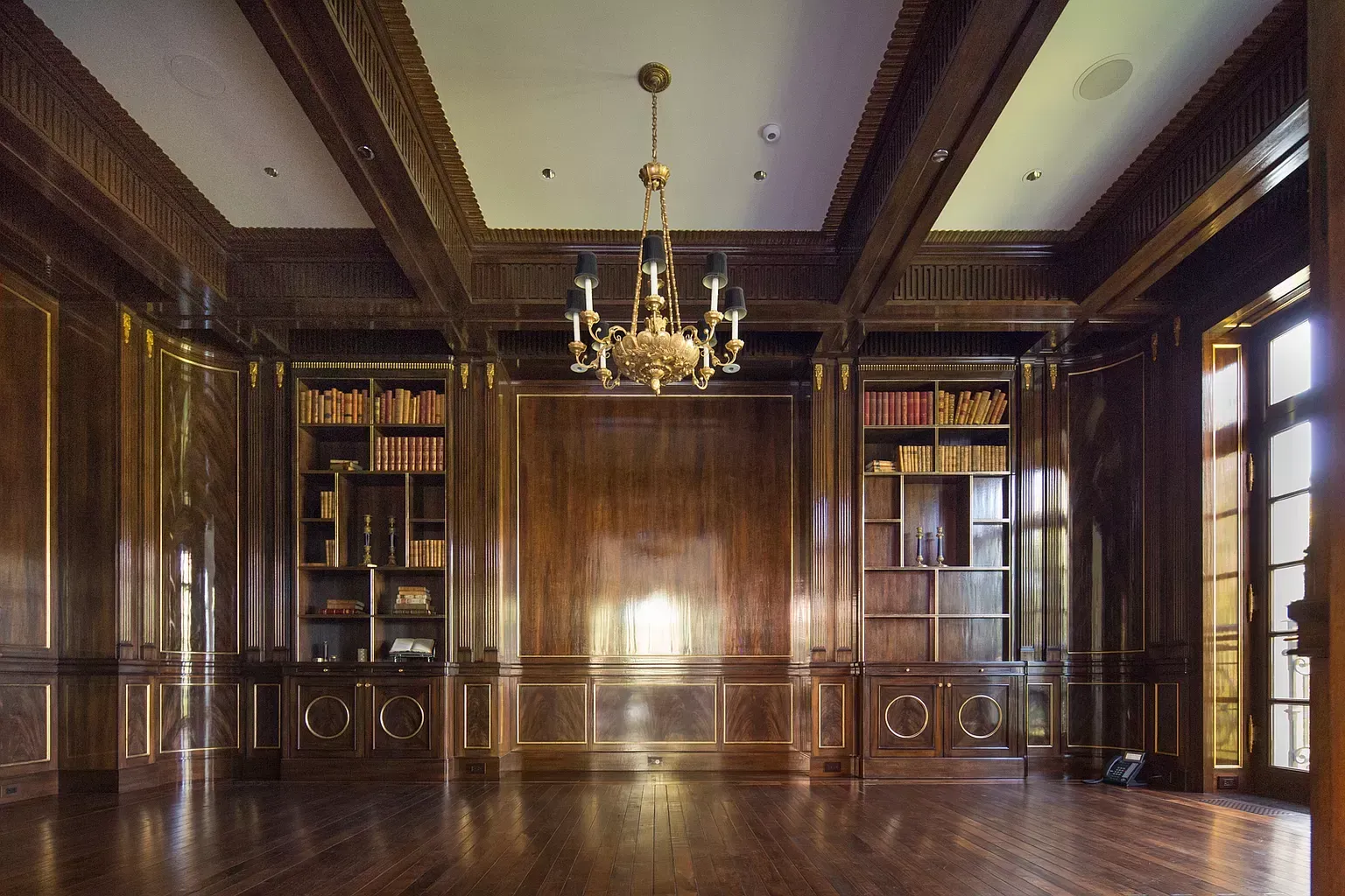 There is a chandelier in the middle of the room.