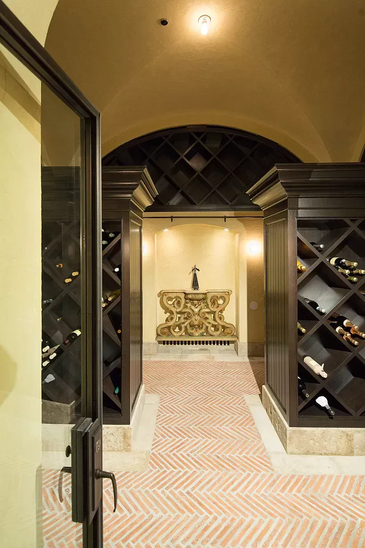 A wine cellar with lots of shelves and bottles of wine.