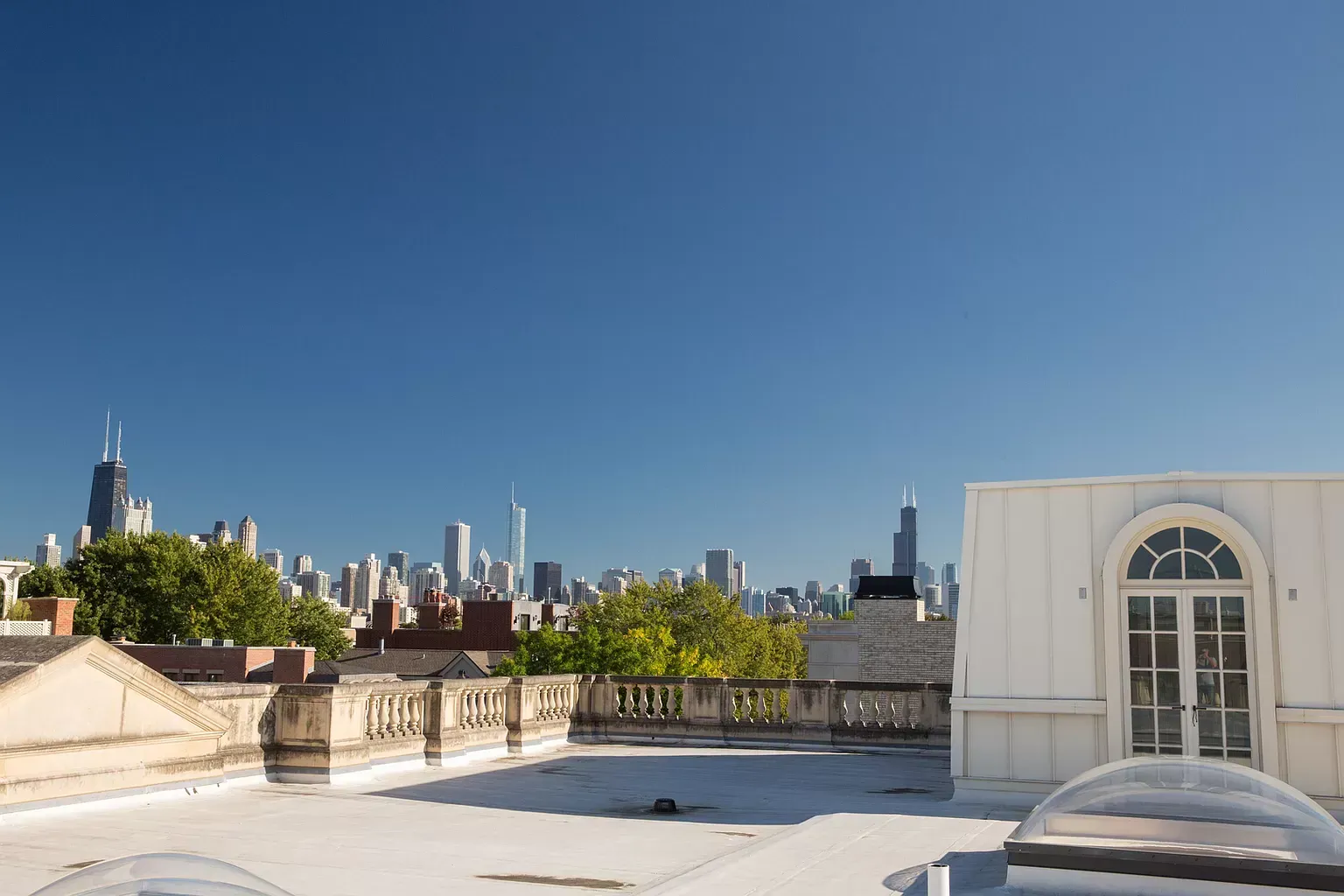 A rooftop with a view of a city skyline