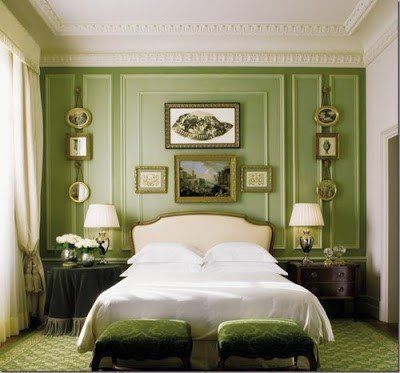 A bedroom with green walls and a bed