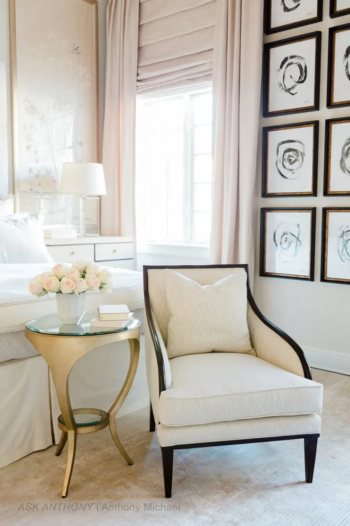 A bedroom with a chair and a table next to a bed.