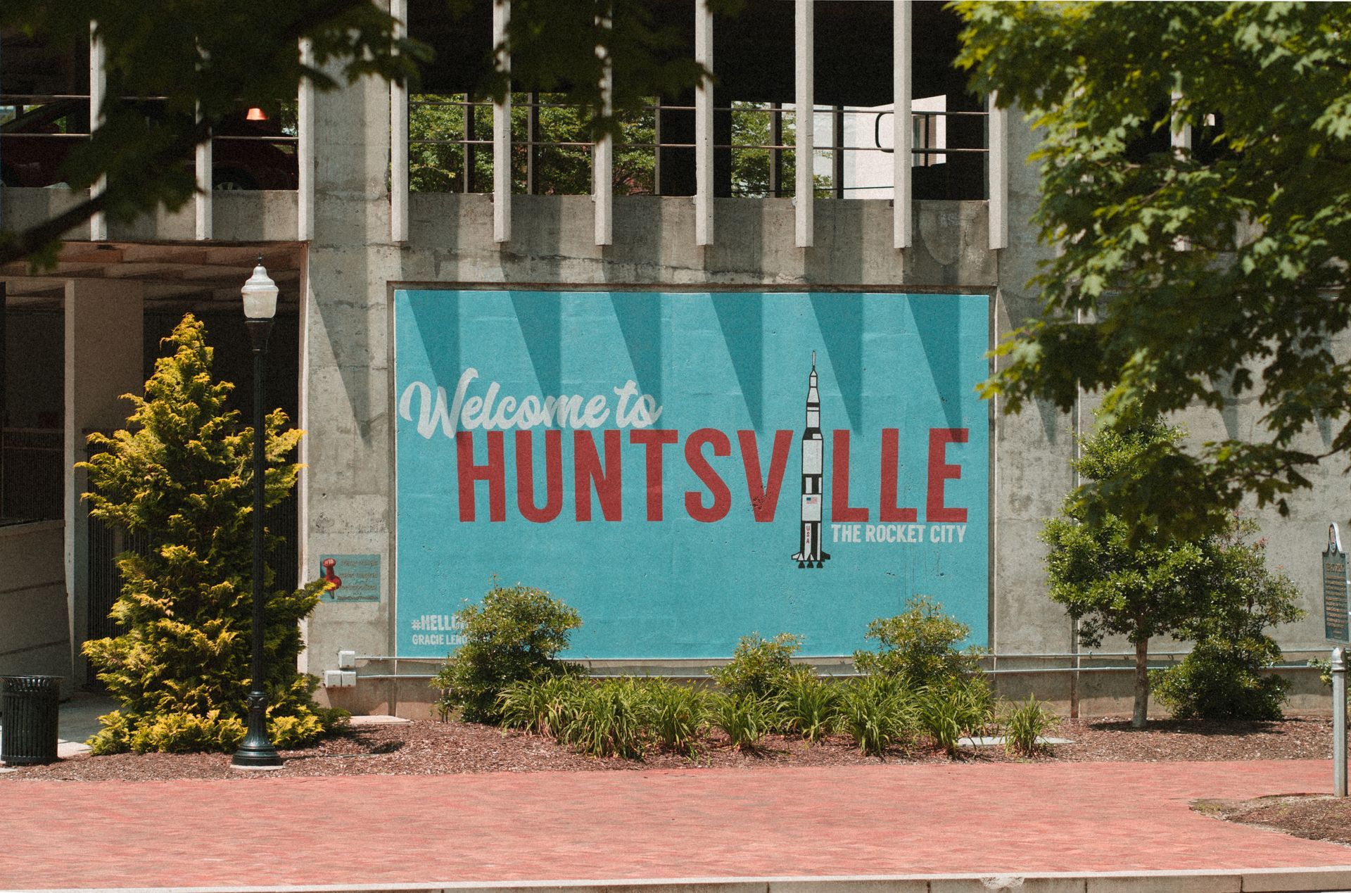 A billboard on the side of a building that says welcome to huntsville
