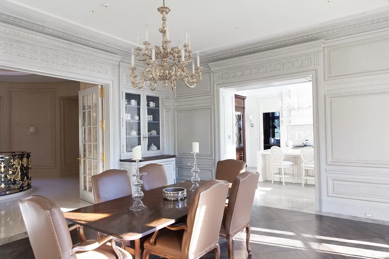 A dining room with a table and chairs and a chandelier