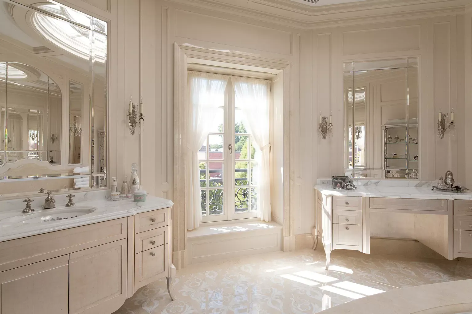 A bathroom with two sinks , two mirrors , a tub and a window.