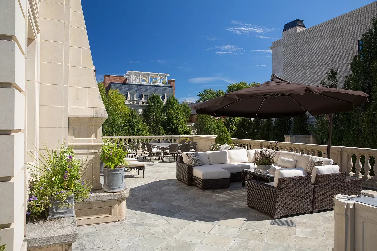 A patio with a lot of furniture and an umbrella