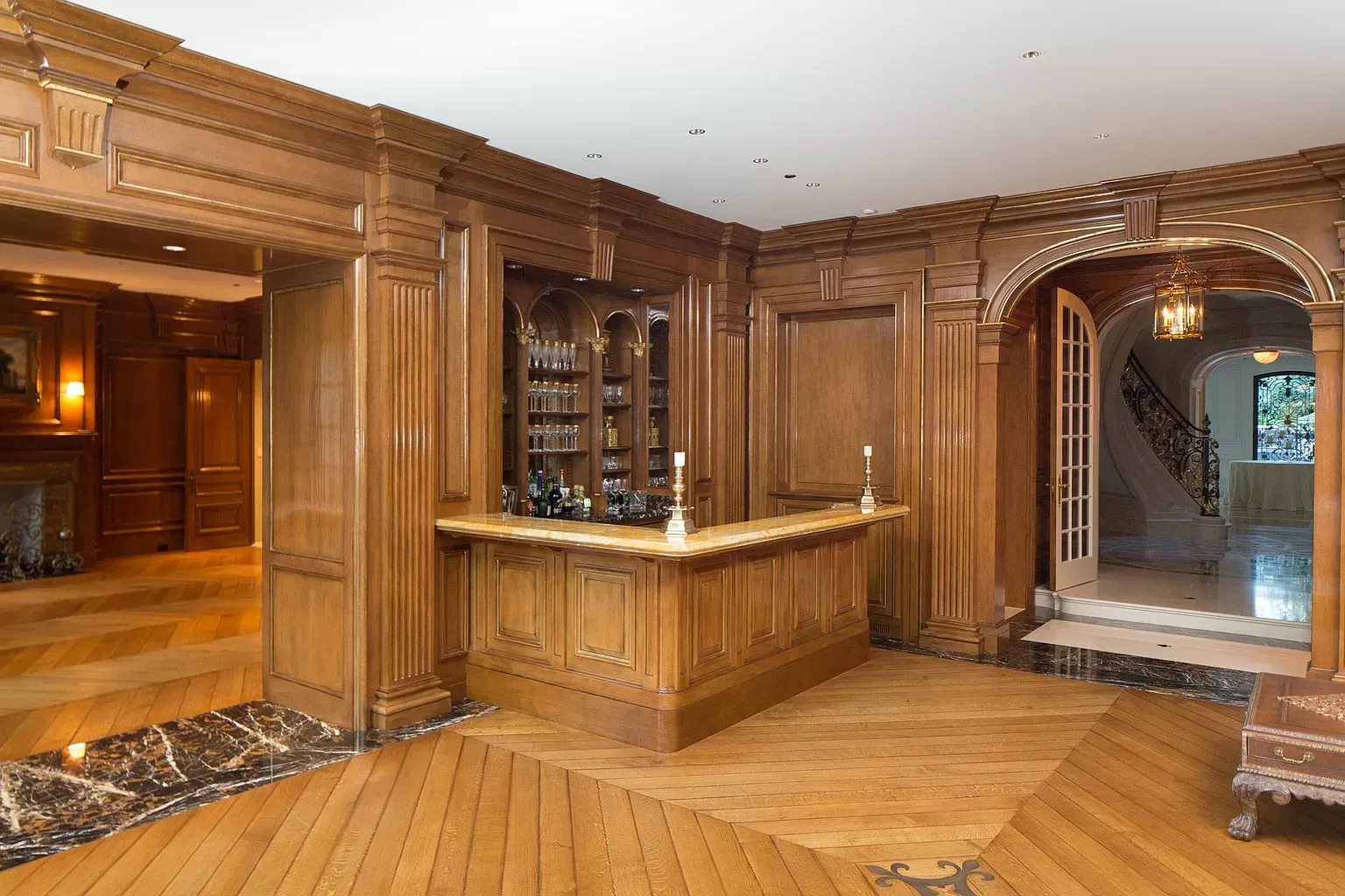 A large room with wood paneling and a bar in the middle