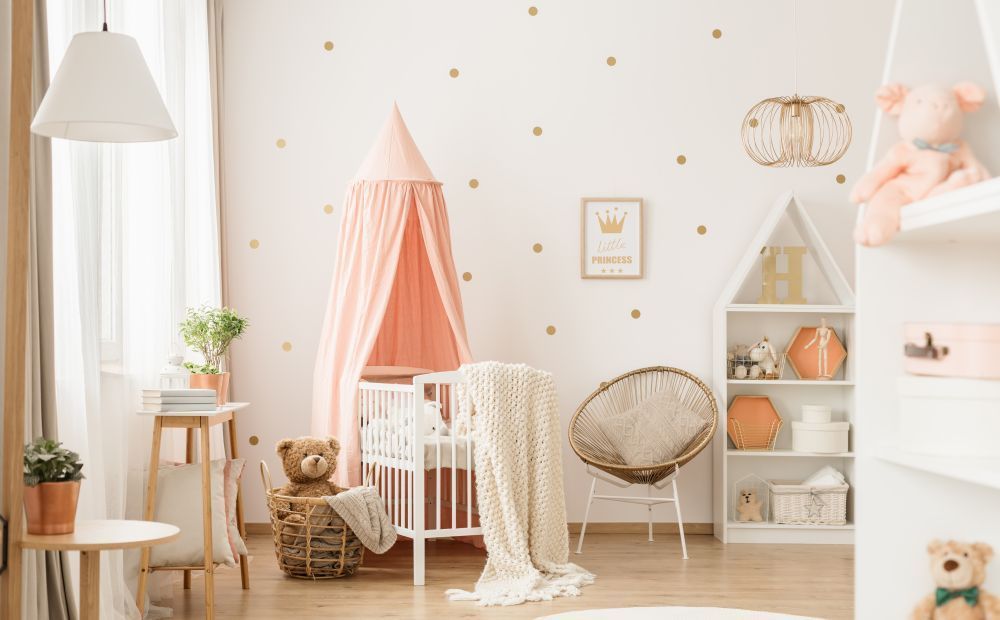 A baby 's room with a crib , chair , shelf , and canopy.