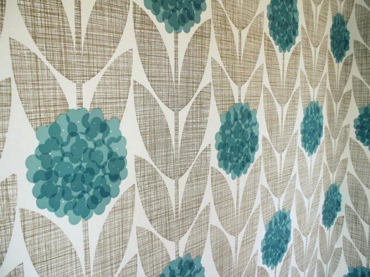 A wall with a pattern of flowers and leaves on it