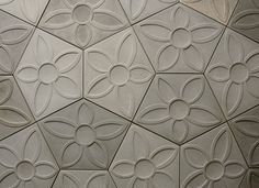 A close up of a tile with a floral pattern on it.