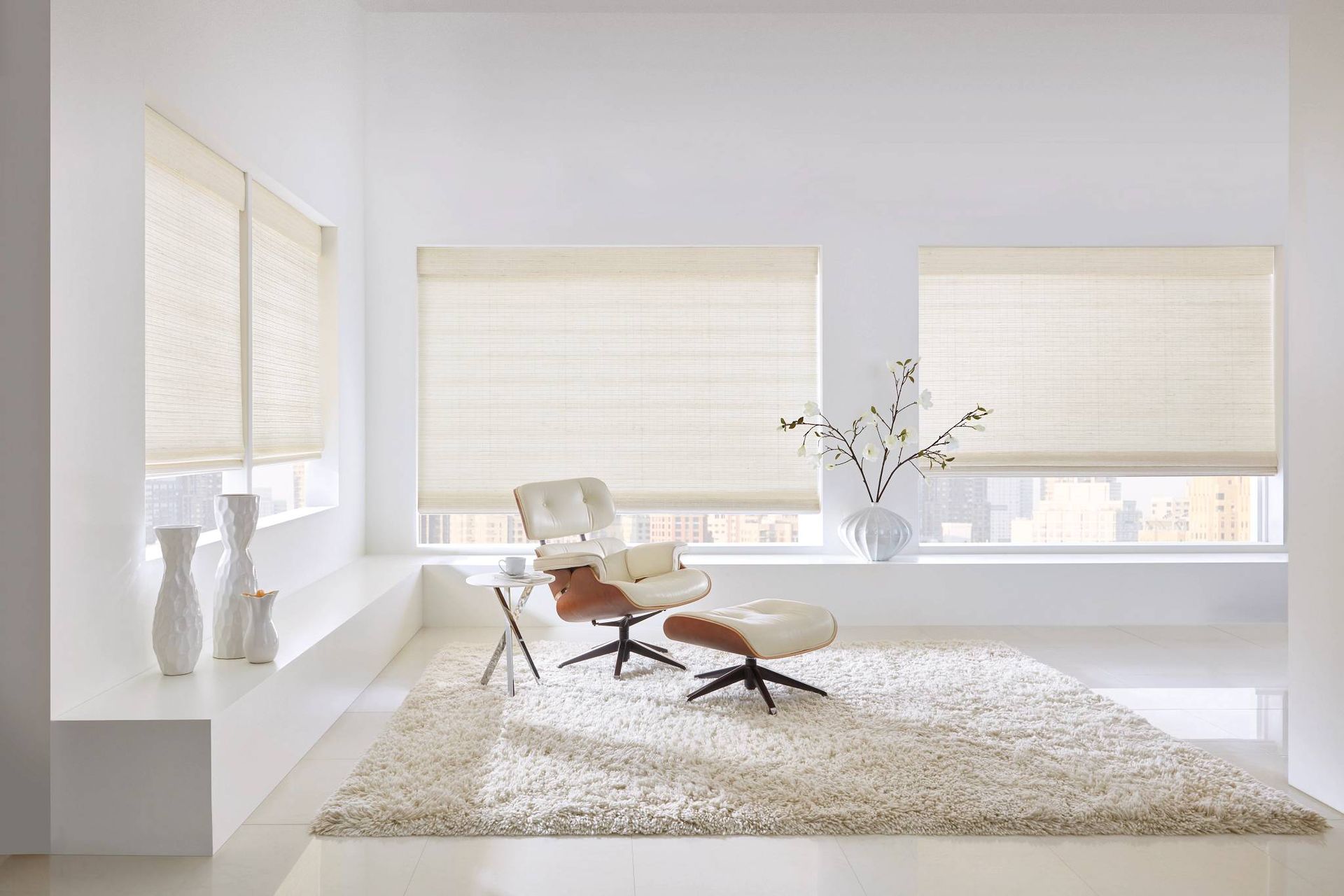 Hunter Douglas Provenance® Woven Wood Shades on large windows in a light and airy seating area at Custom Wood Shutters and Blinds near Tustin, CA