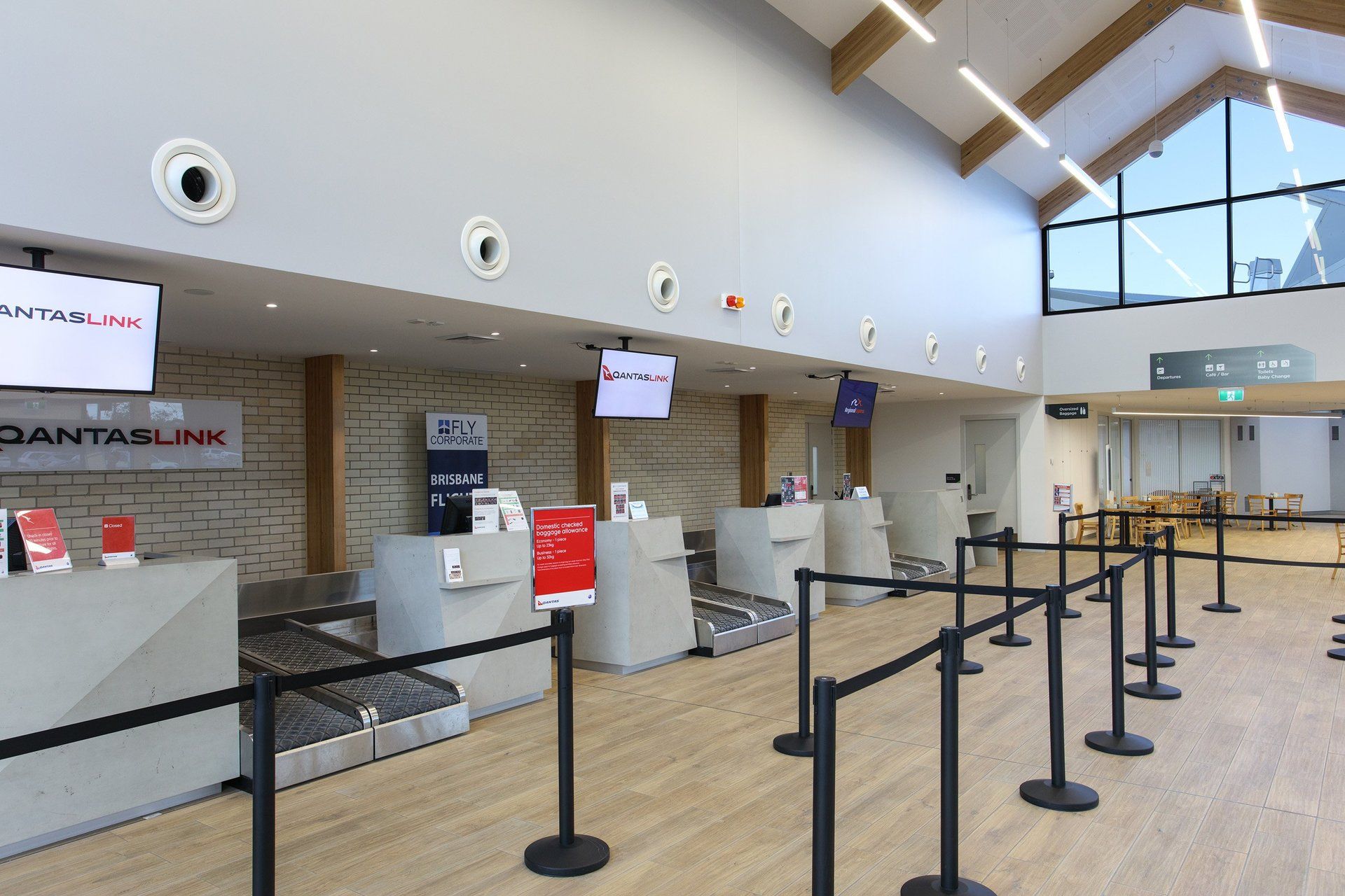 Check in area of armidale airport with a sign that says ' qantaslink ' on it