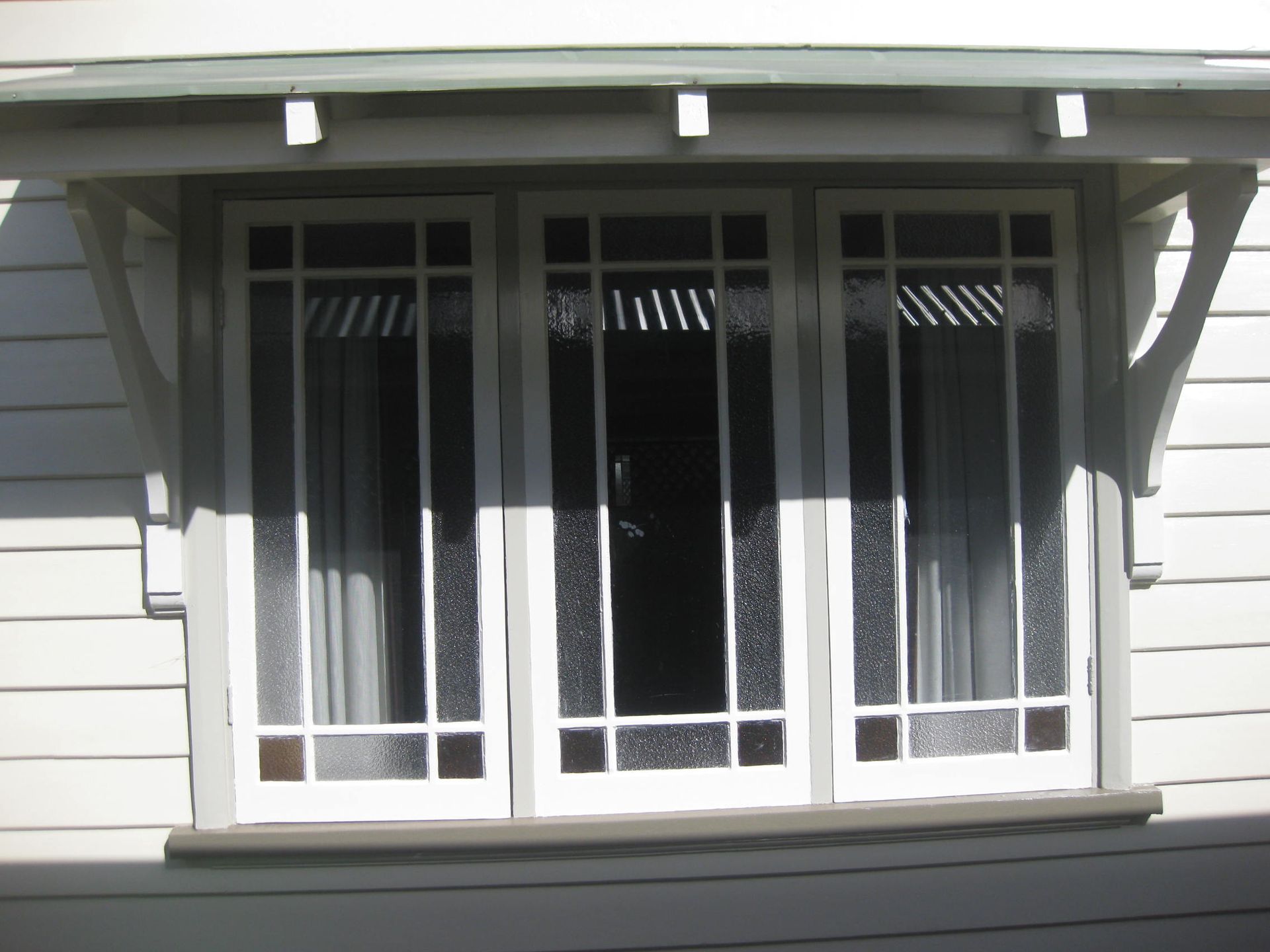 Close up view of three windows with freshly painted trims