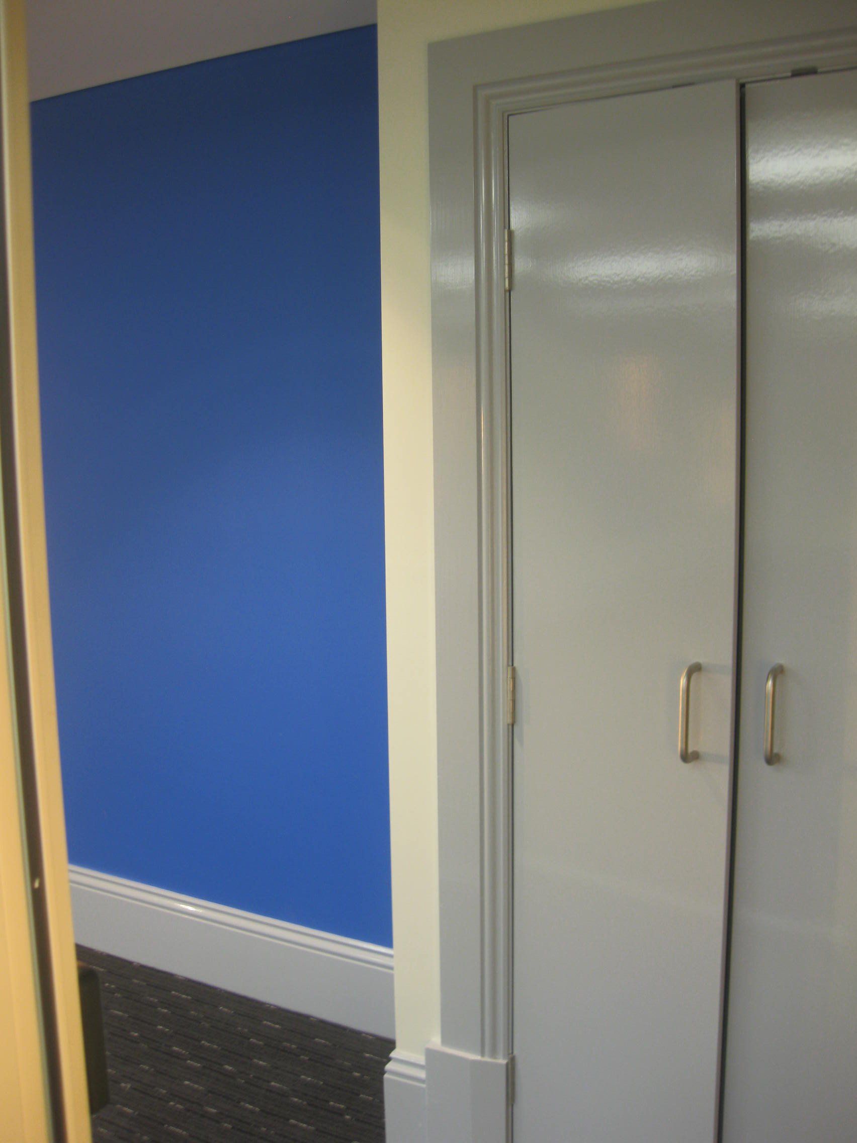 Bright blue feature wall in small room at the Catholic Cathedral Precinct in Armidale