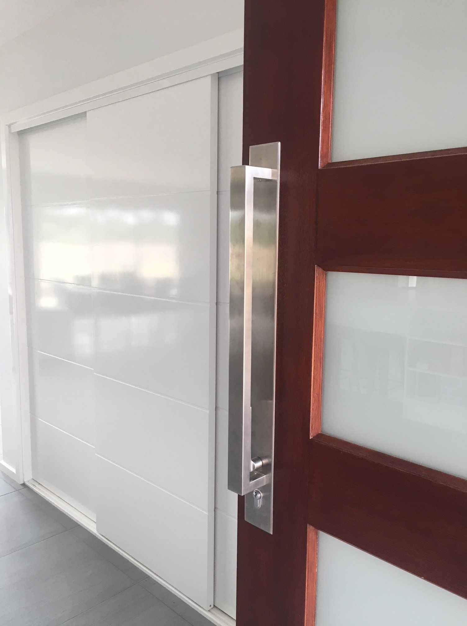 a sliding glass door with a stainless steel handle
