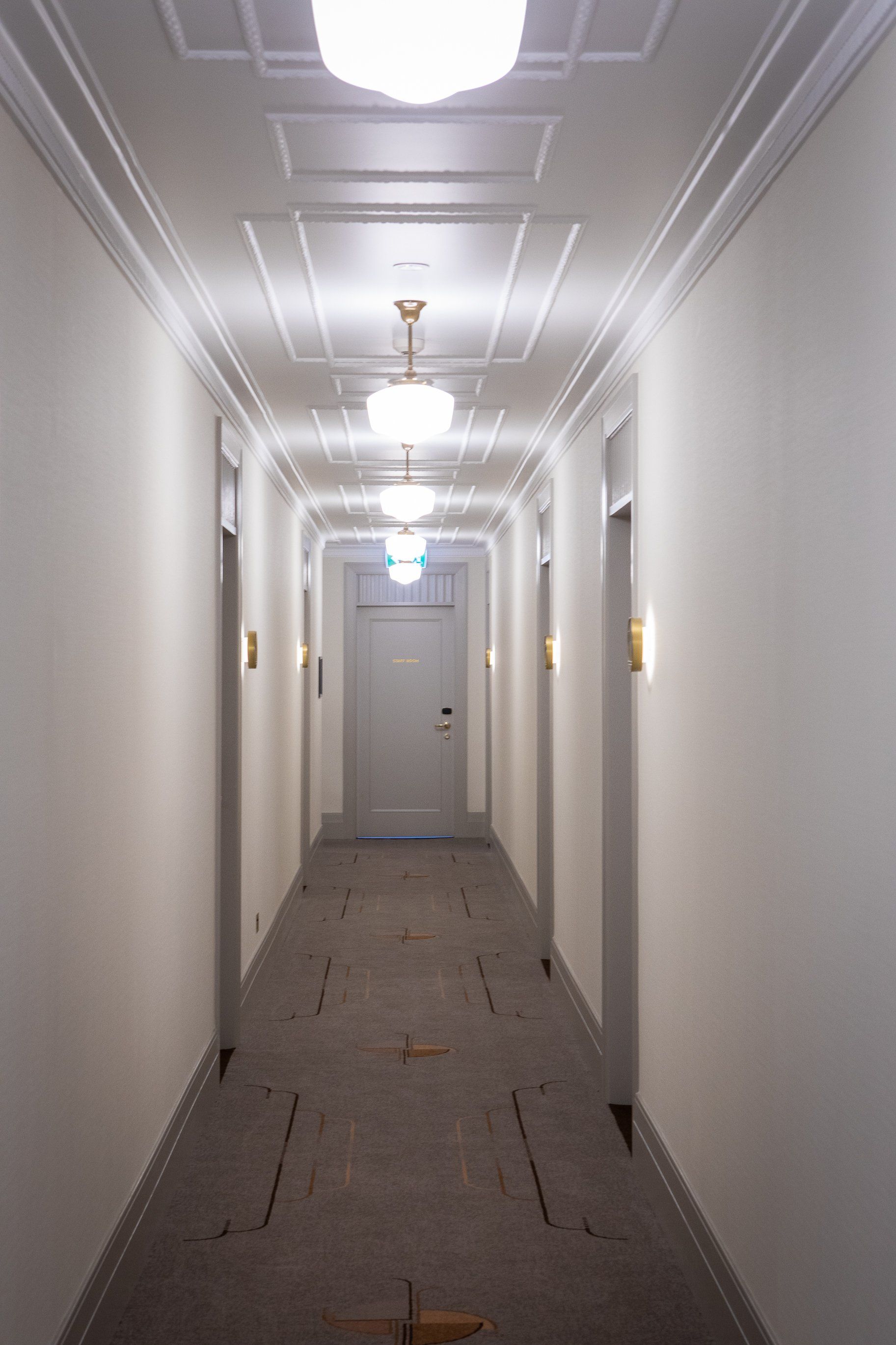 long hallway with doors on both sides at tattersalls hotel