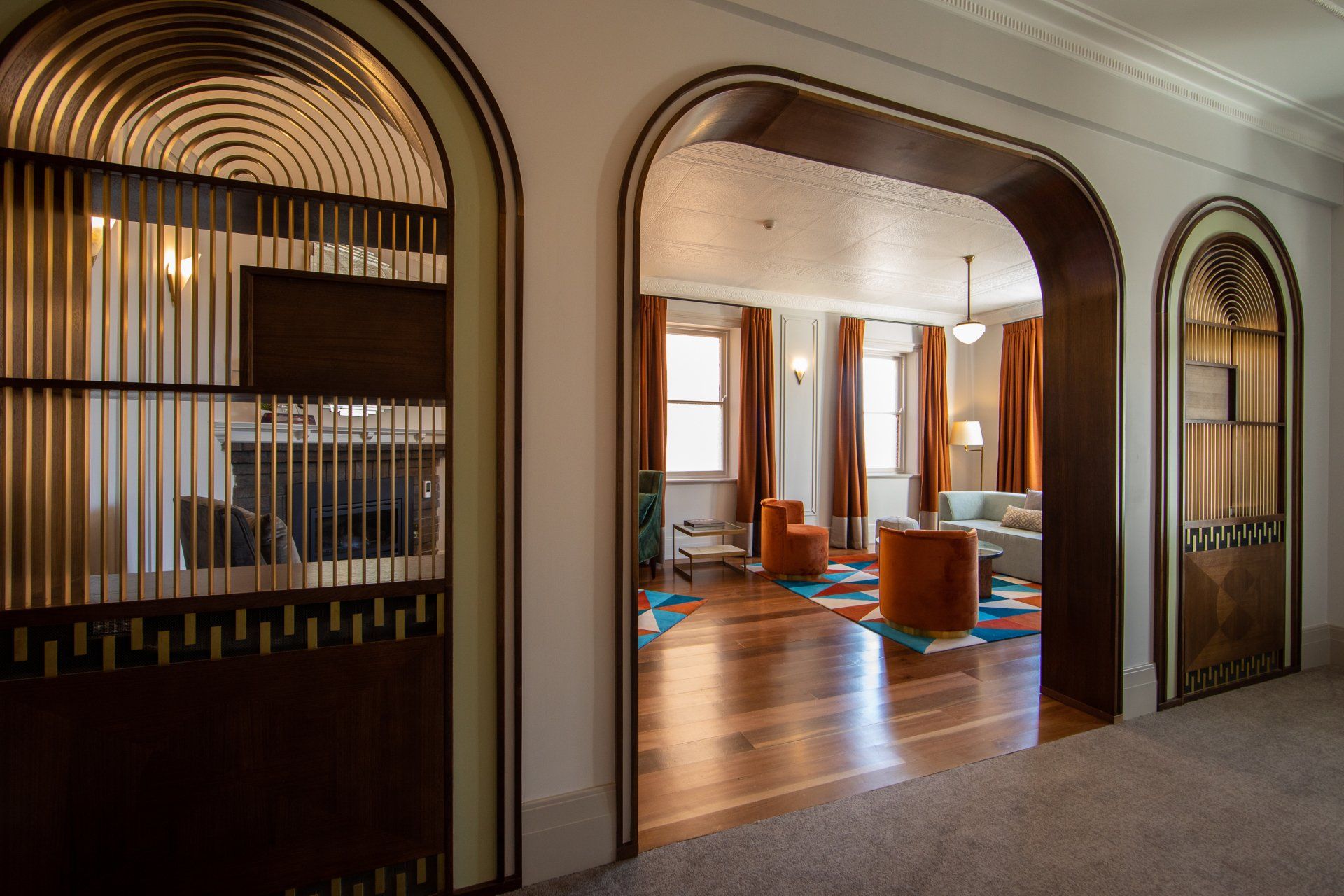 a hallway with arched doors leading to a common area at tattersalls hotel.
