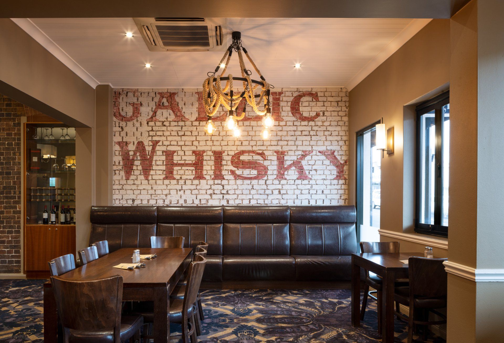 a room with a brick wall that says whisky on it