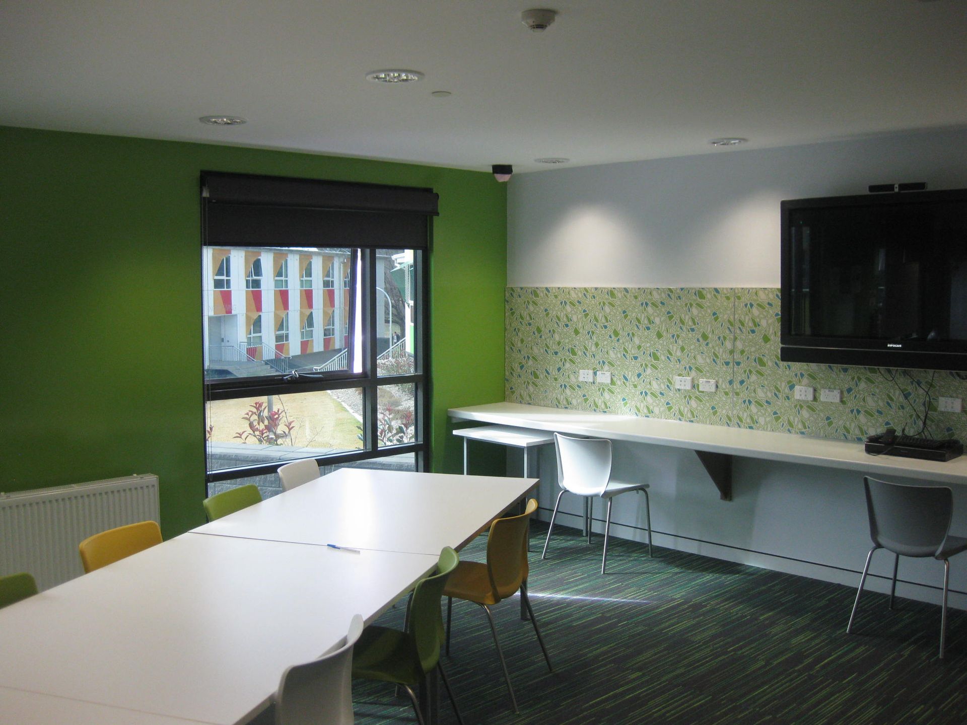 common room with painted green feature wall 