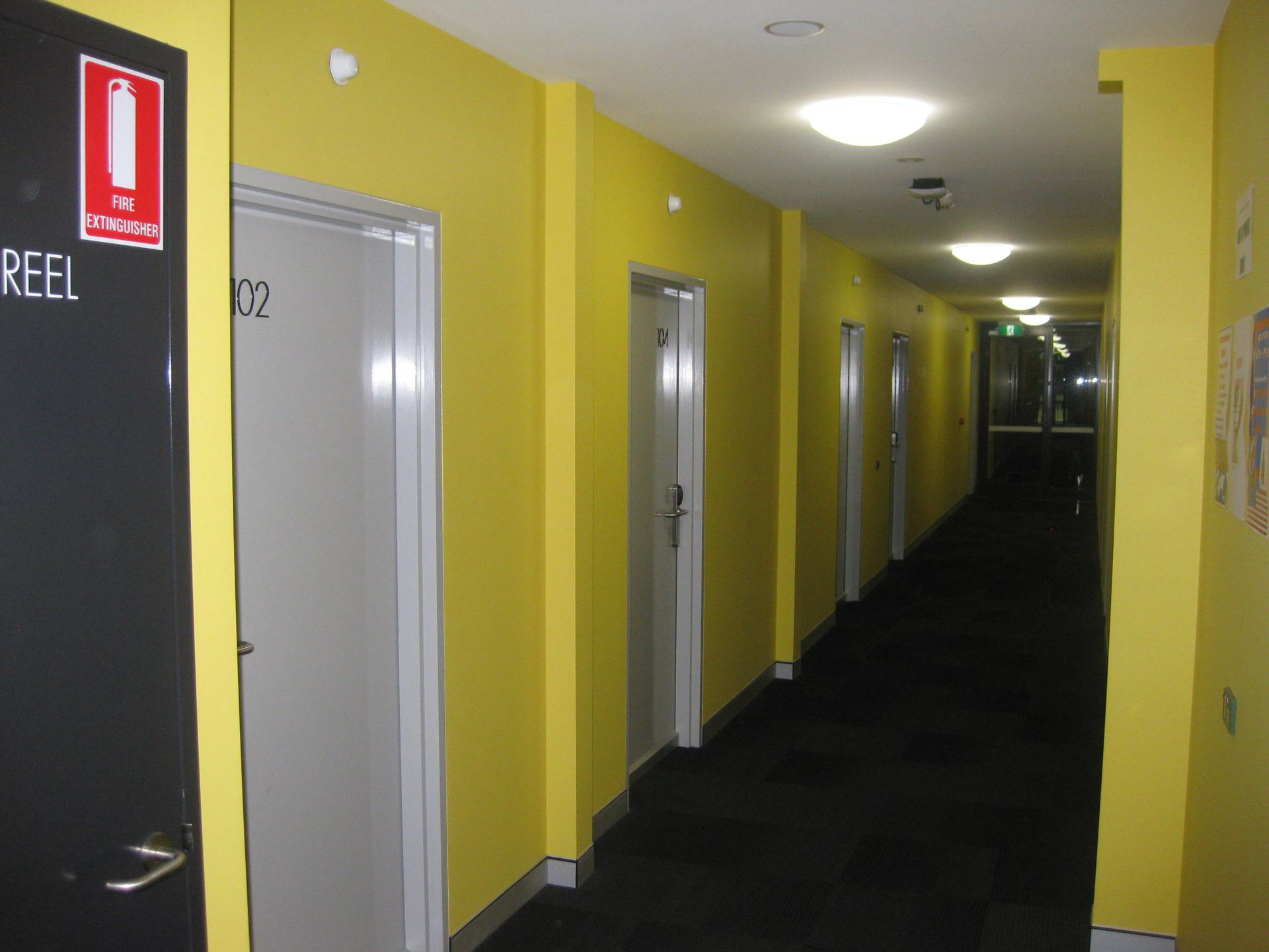 long corridor with bright yellow walls at wright college in armidale