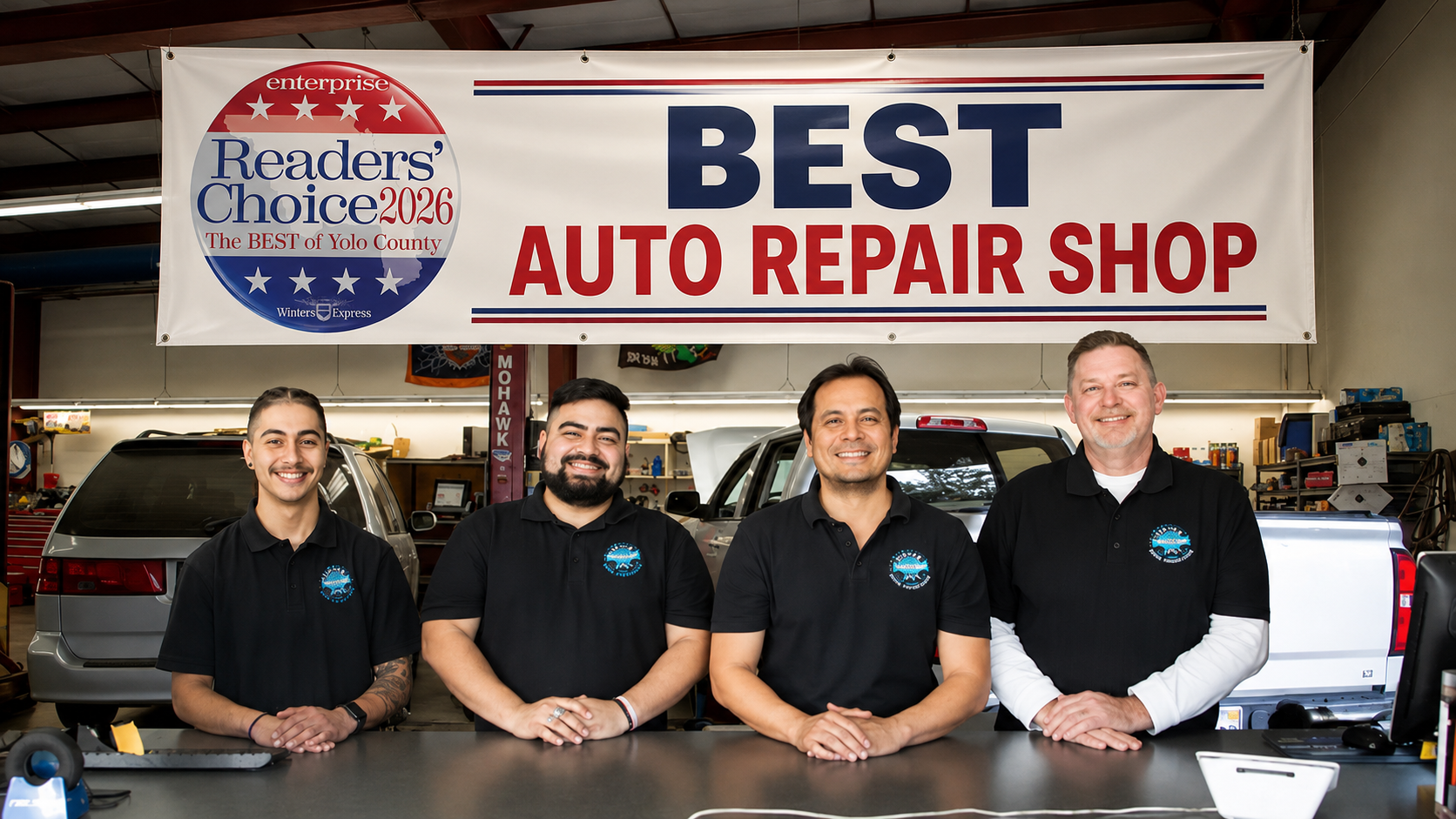 Four auto shop employees stand behind a counter under a “Best Auto Repair Shop” sign.