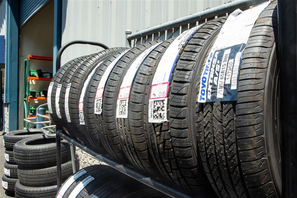 Tires on display in a rack outside a store.  Labels visible on the tires.