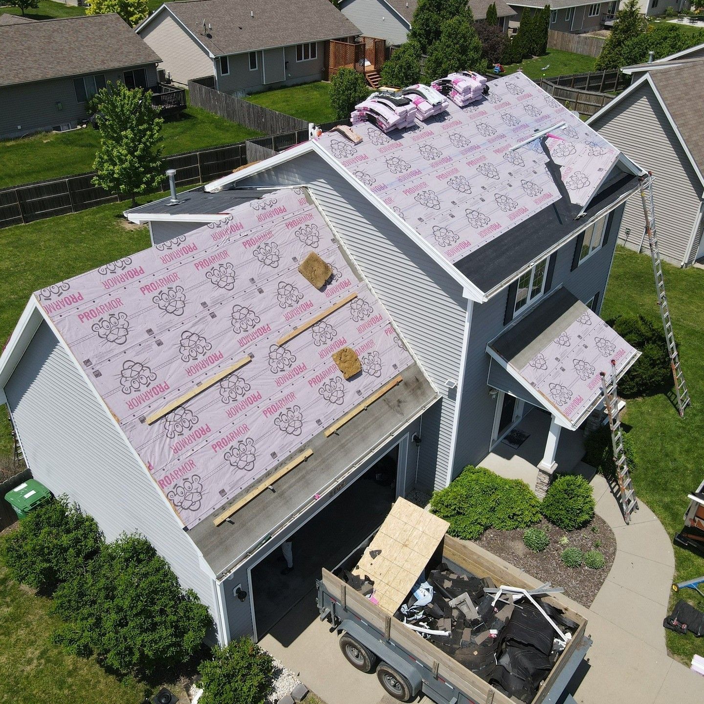 An aerial view of a house with a roof being installed.