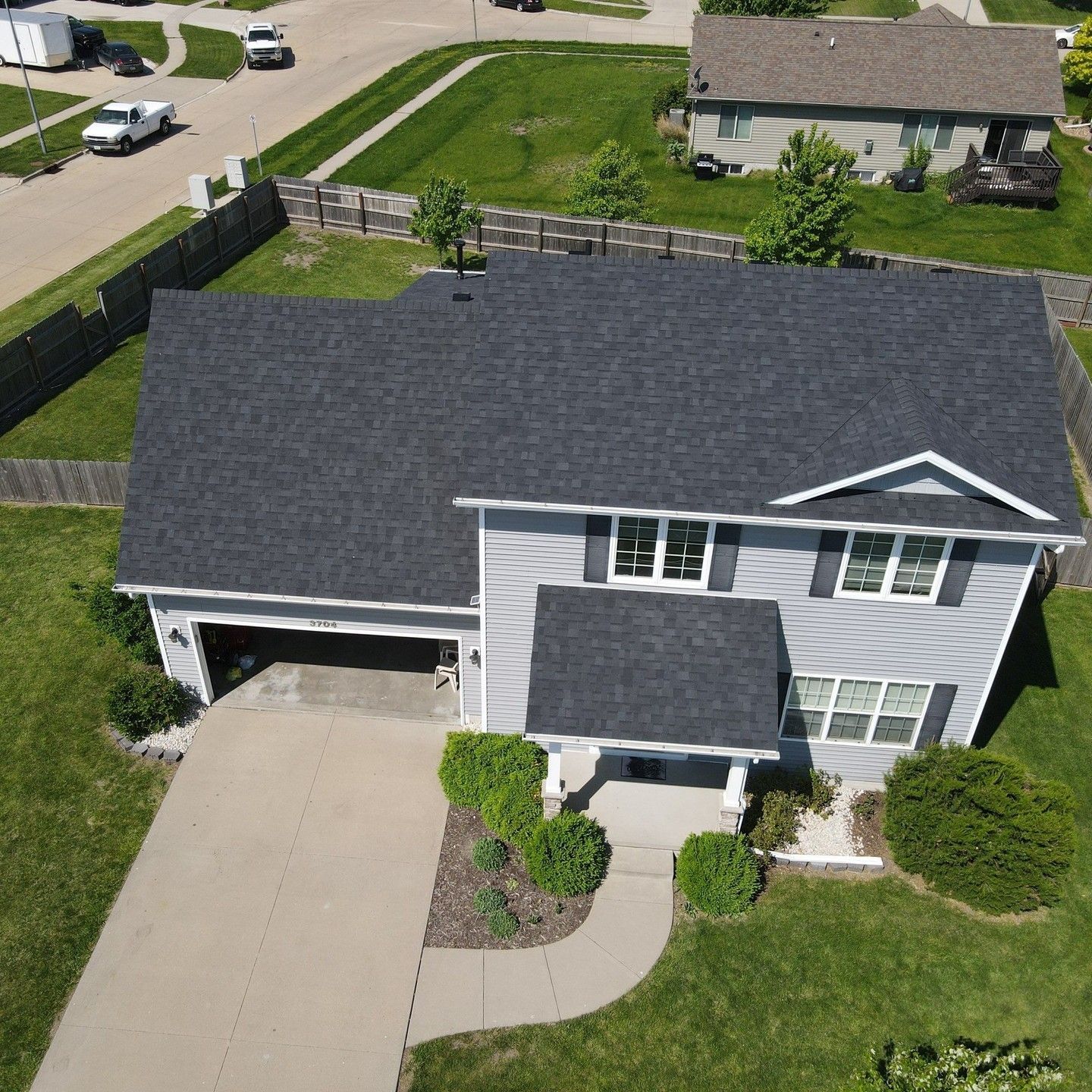 An aerial view of a house with a black roof