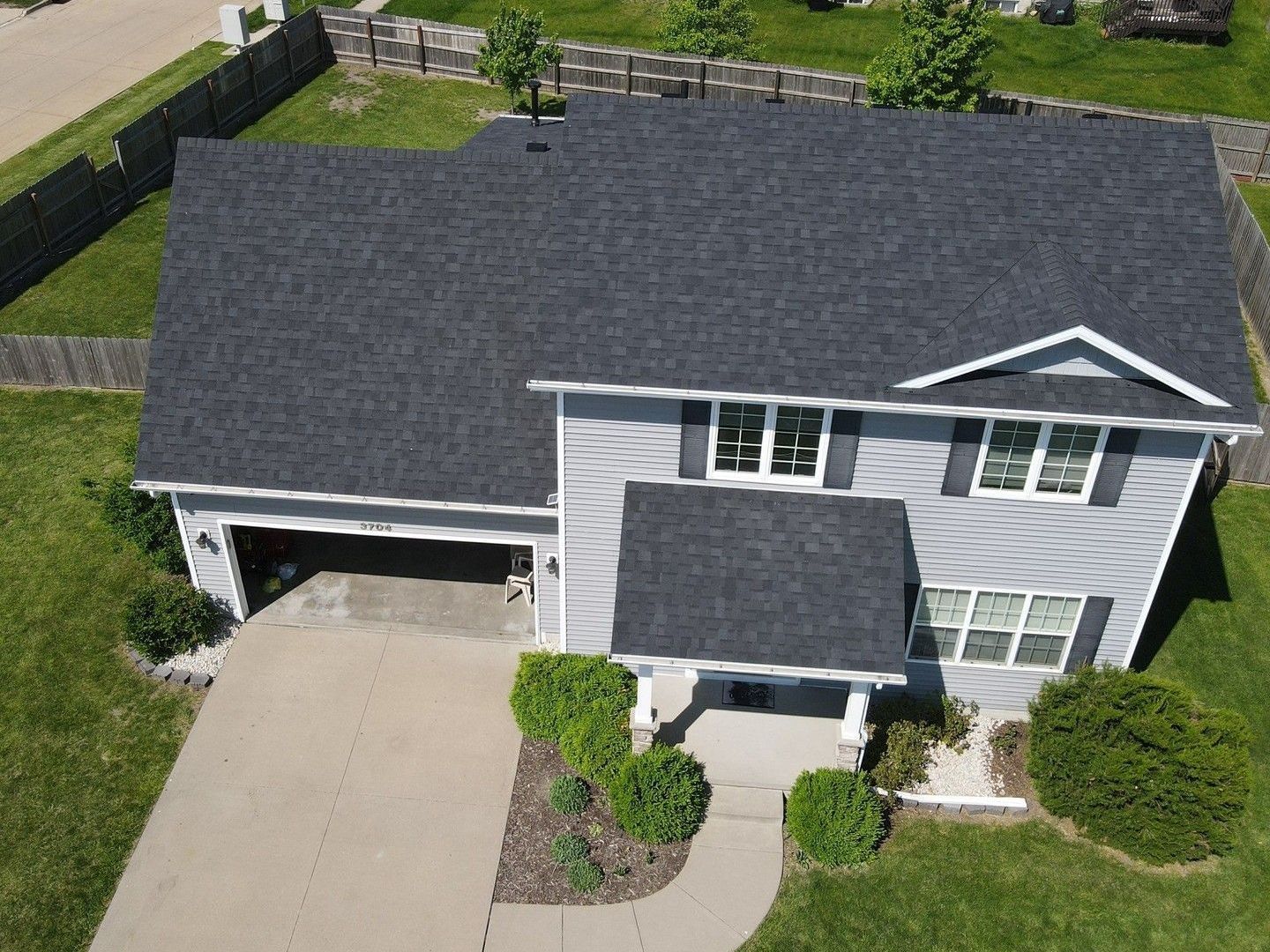 An aerial view of a house with a black roof.