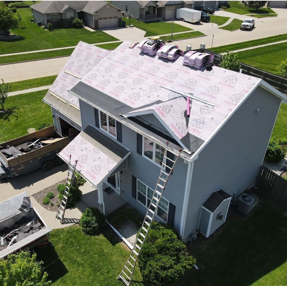 An aerial view of a house with a pink roof