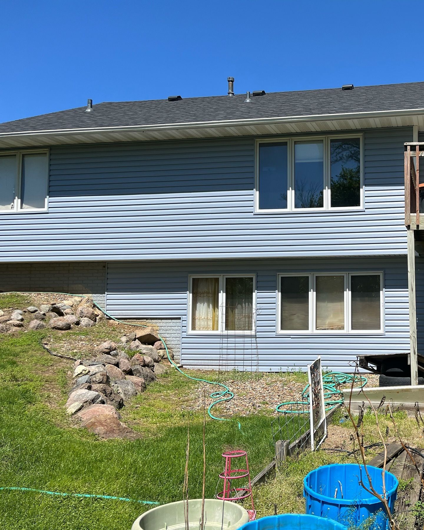 A house with a lot of potted plants in front of it