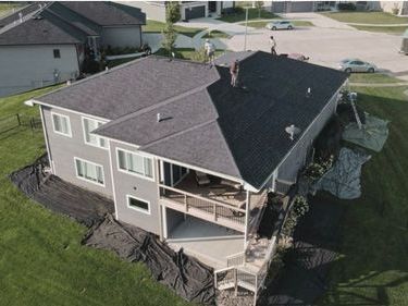 An aerial view of a house with a roof that is being built.