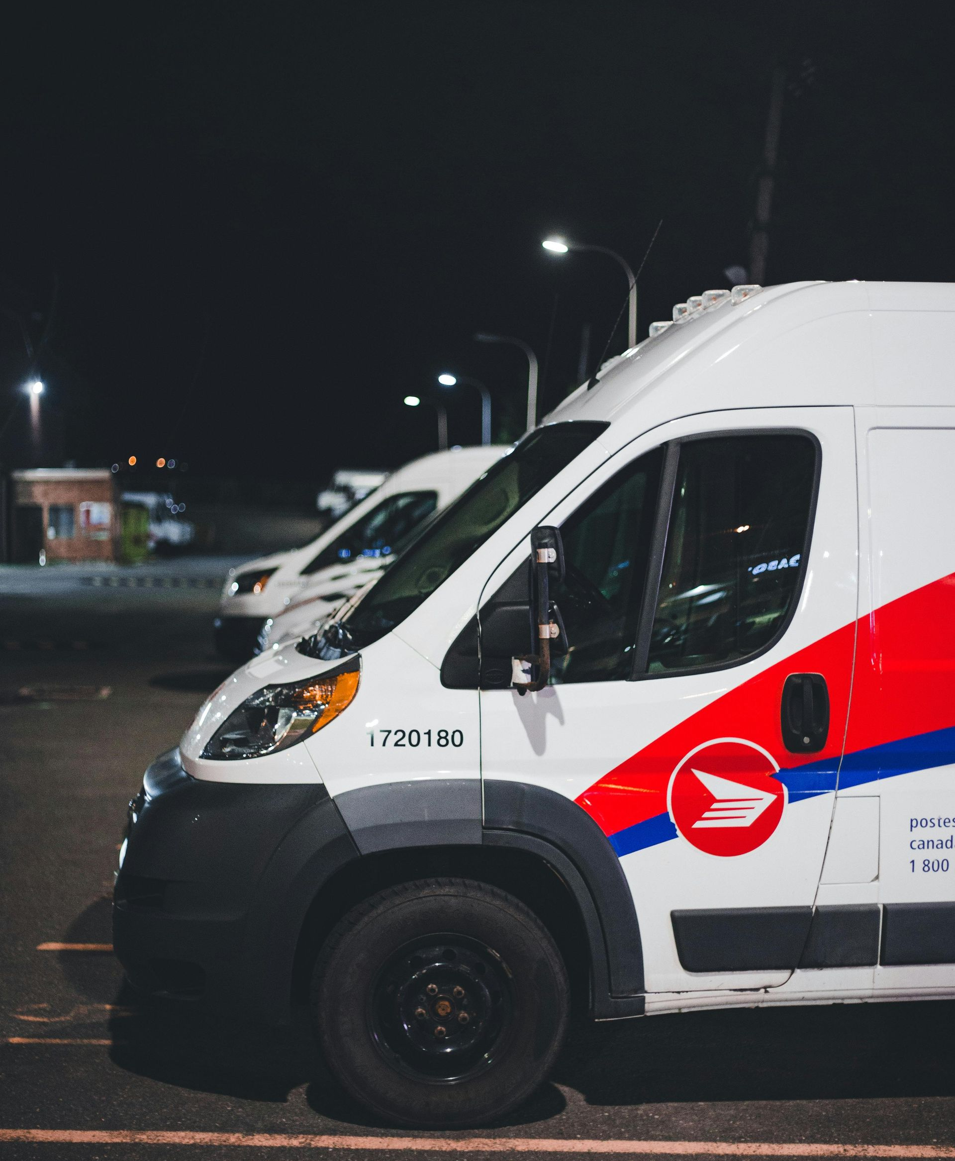 Red car with extensive front-end damage, including deployed airbag, on gravel.