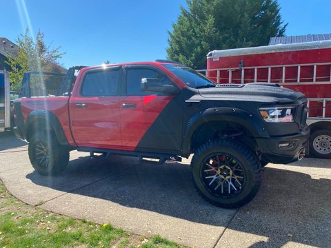 Red truck with brand new tires.