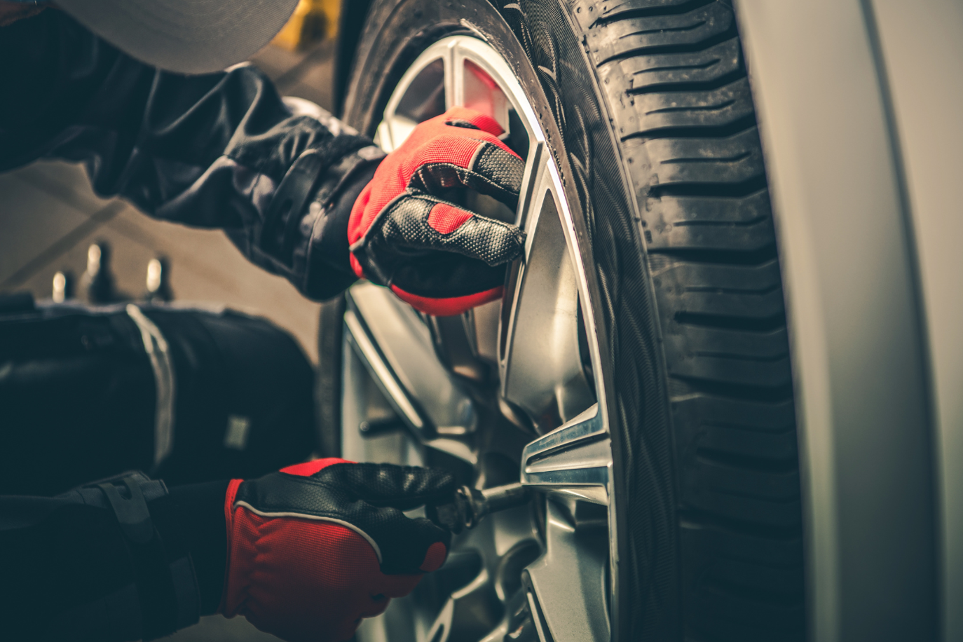 Car mechanic changing seasonal tires