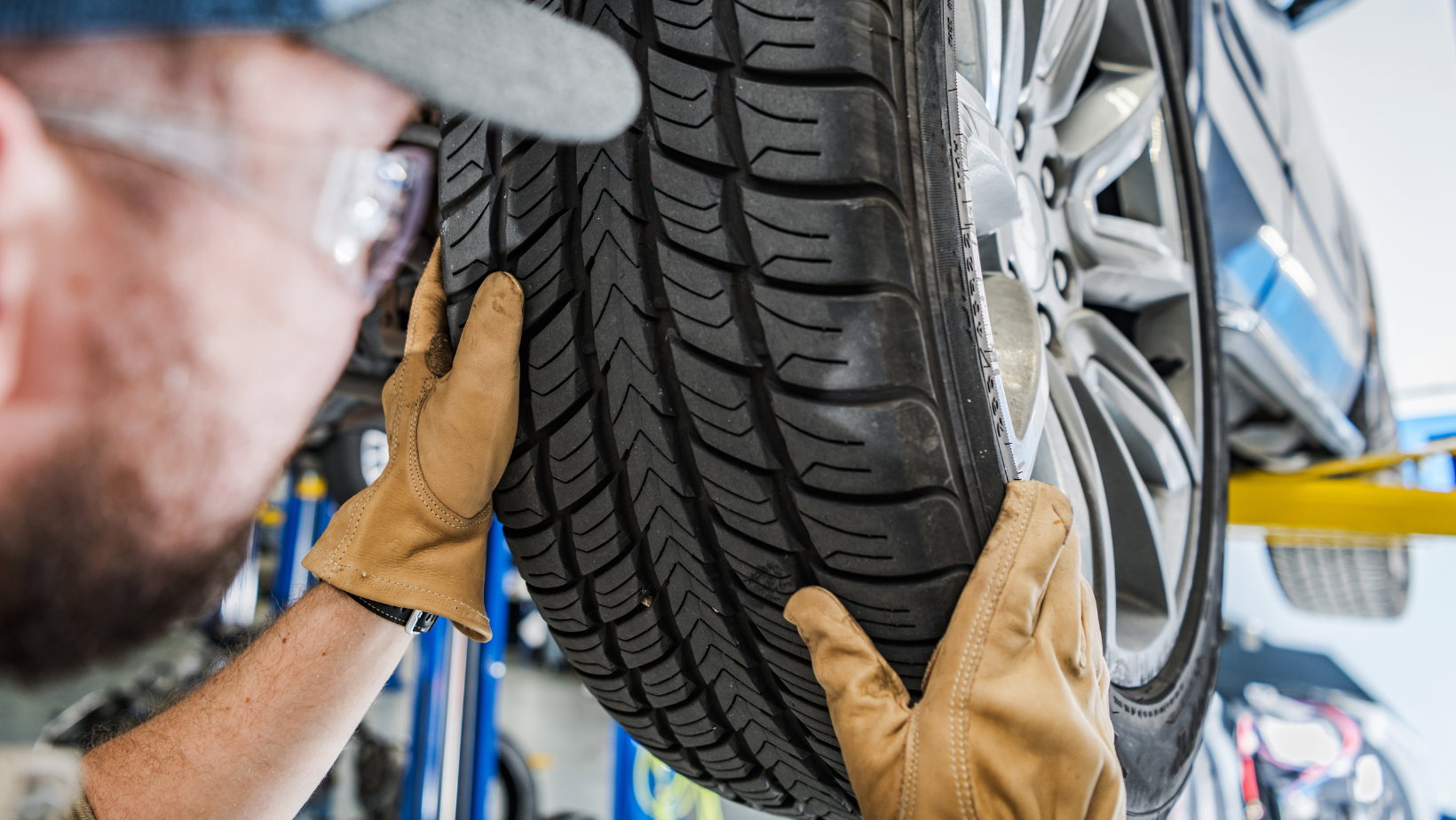 Car mechanic changing tires