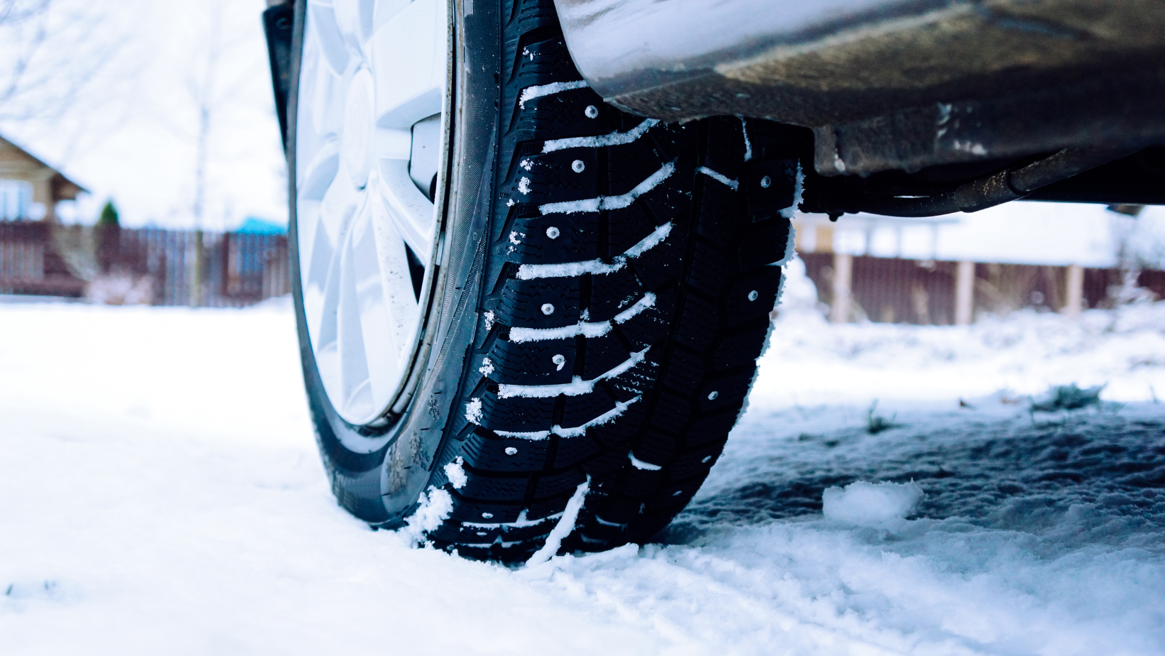 Car winter studded tires on a snowy road