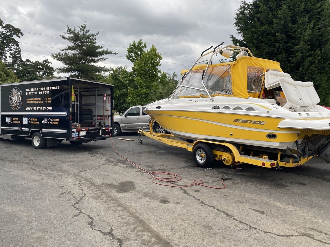 New Tires getting put on a yellow boat.