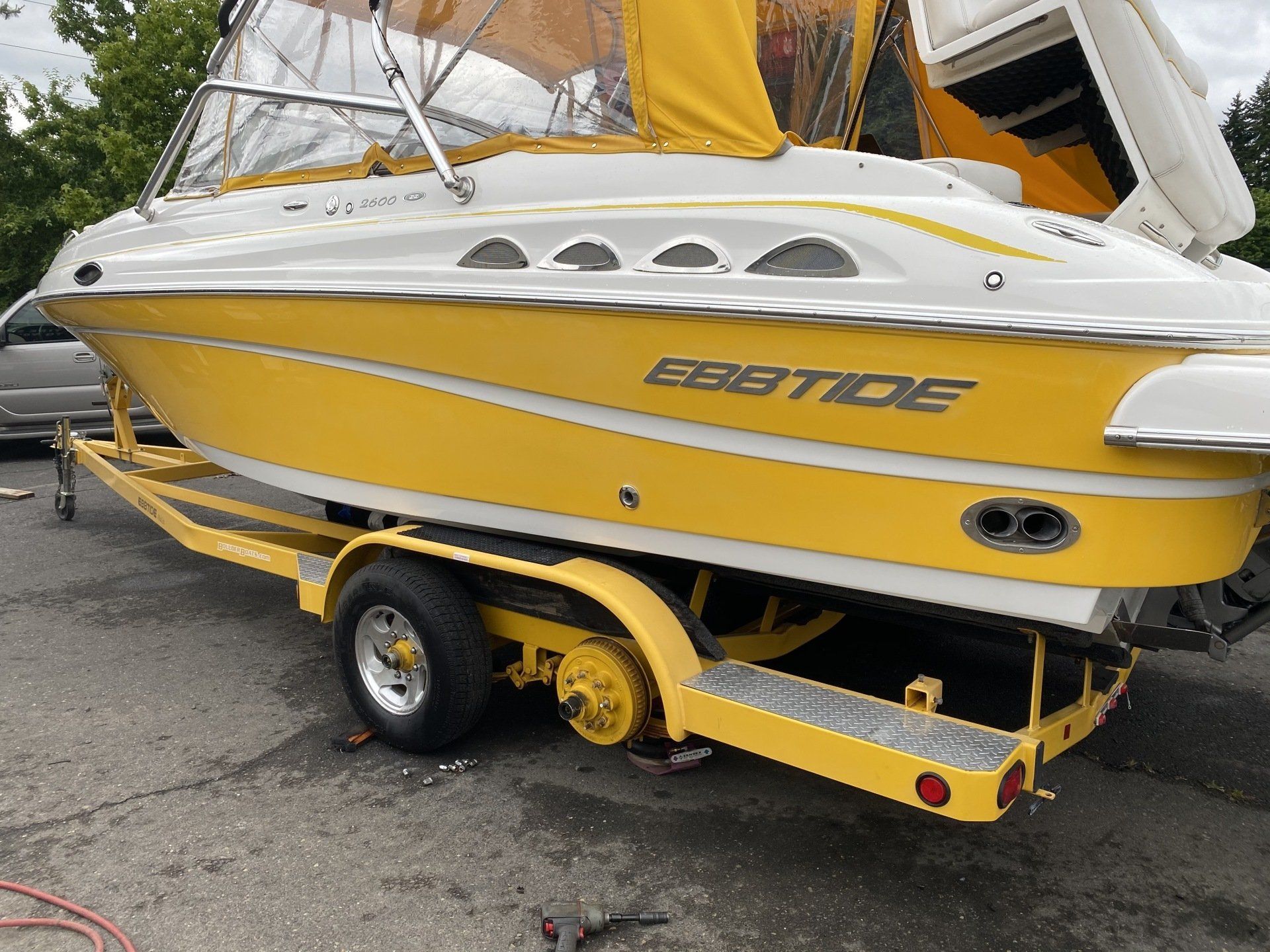 New tires on a yellow boat.