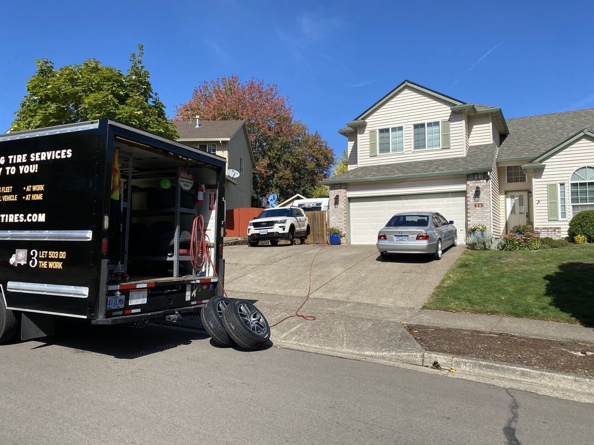 Picture of the 503 Tires truck parked outside of a residential house.